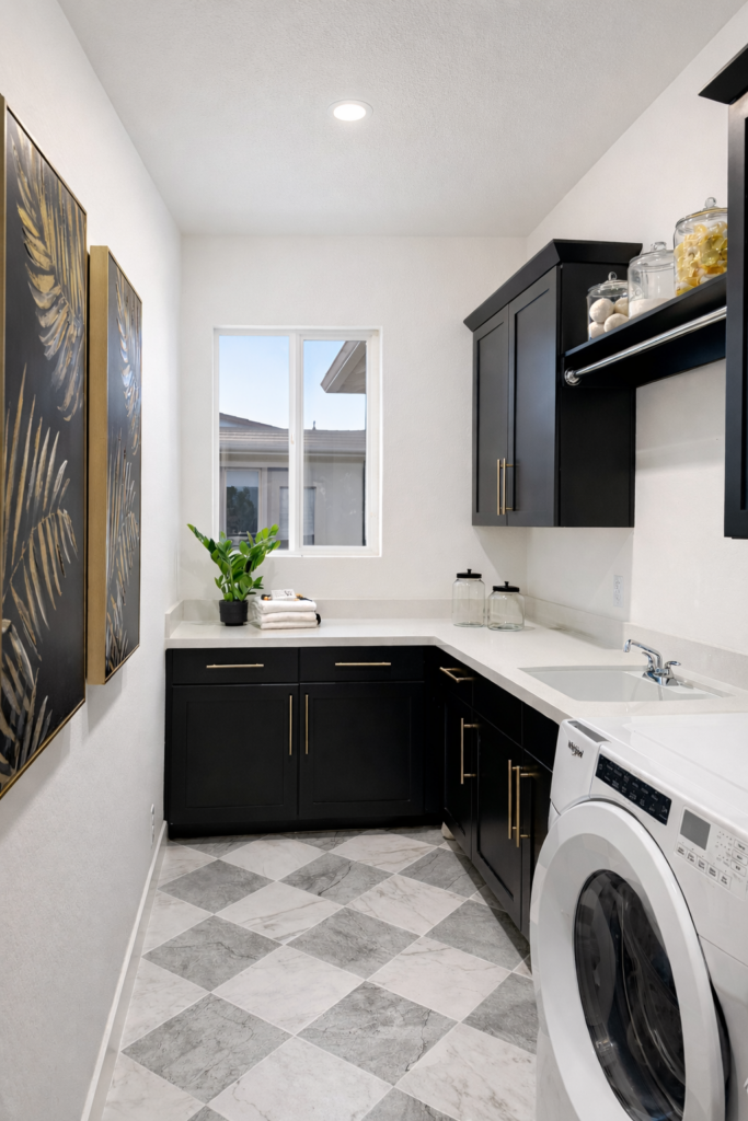 Styled laundry room with organized storage and fresh décor, demonstrating how thoughtful staging helps homes feel move-in ready for buyers.